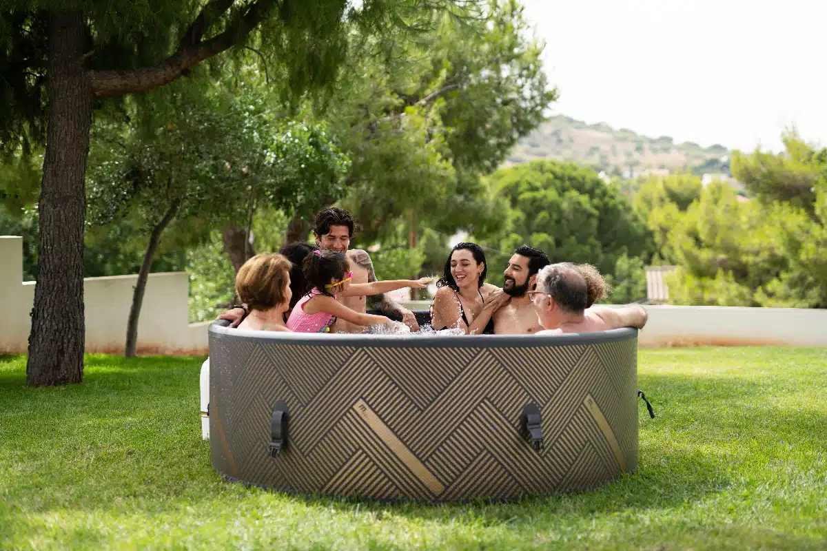 A family enjoying the convenience of MSpa Mono 8 inflatable hot tub in their garden.